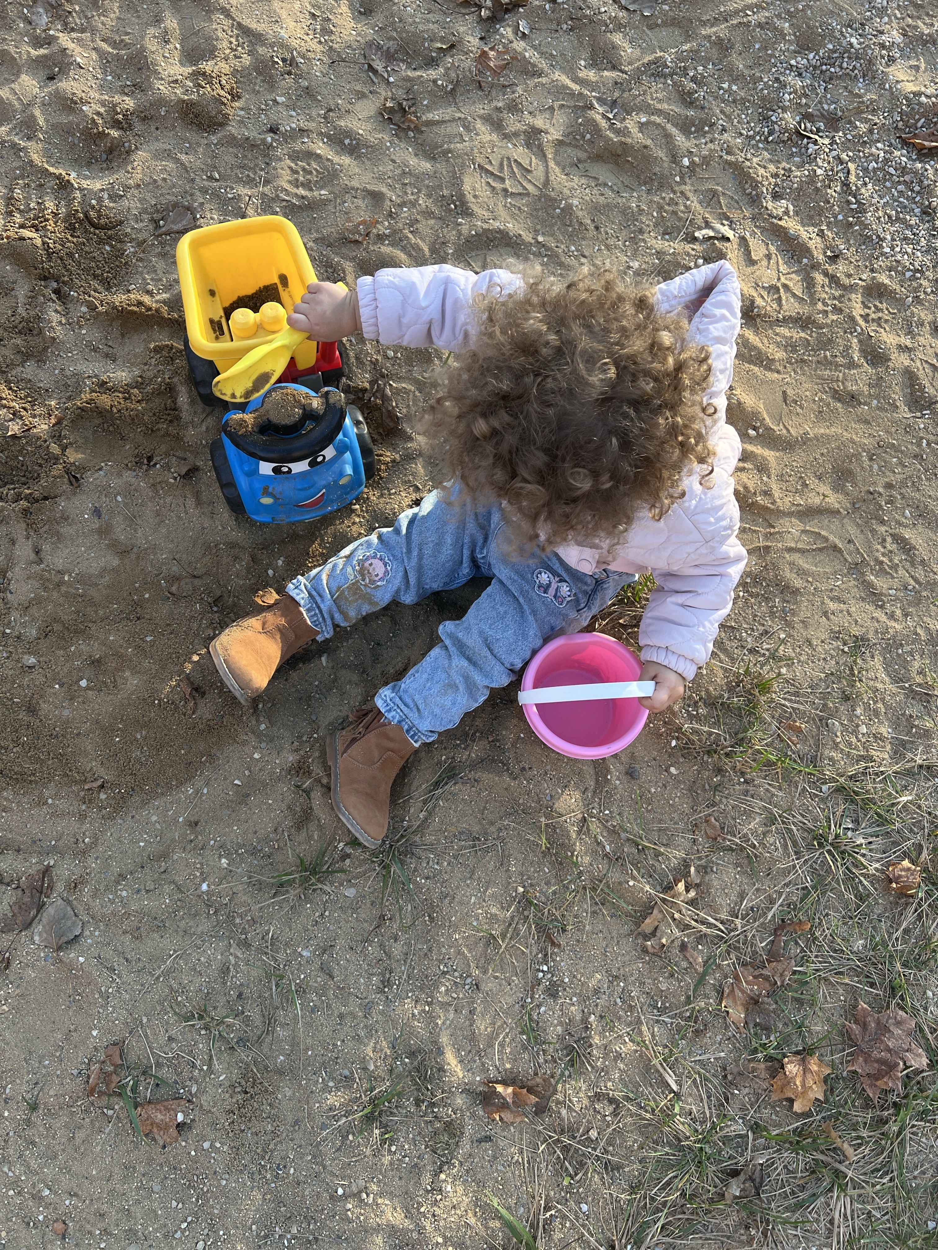 toddler playing in sand